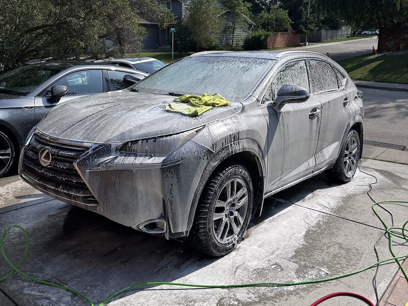Lexus NX covered in foam before hand wash — mobile detailing Calgary
