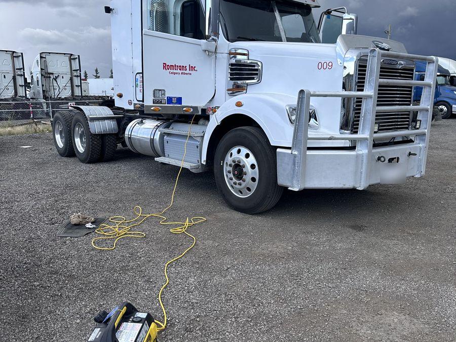 Freightliner highway tractor being detailed in a Calgary yard, powered by our own generator