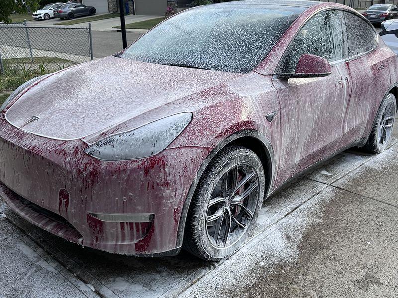 Tesla Model Y covered in foam during a mobile hand wash in Calgary